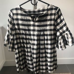 Buffalo plaid shirt with bell sleeves.